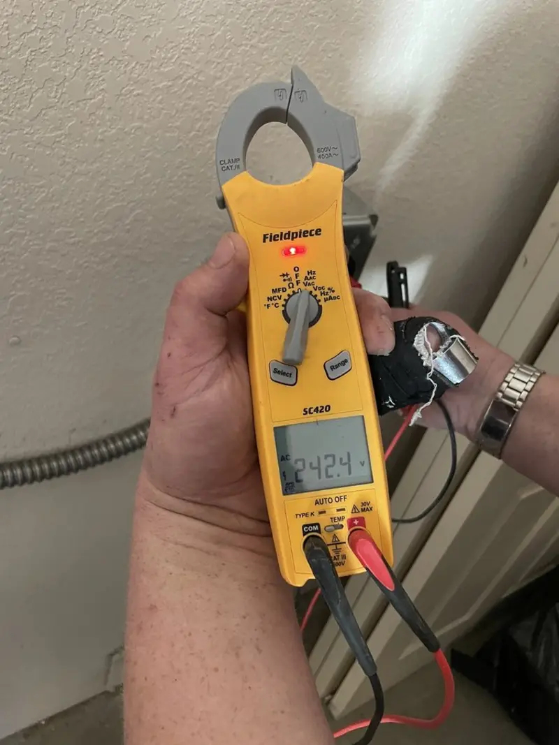 Voltage testing with clamp meter during Ceiling Fan Installation in Clayton